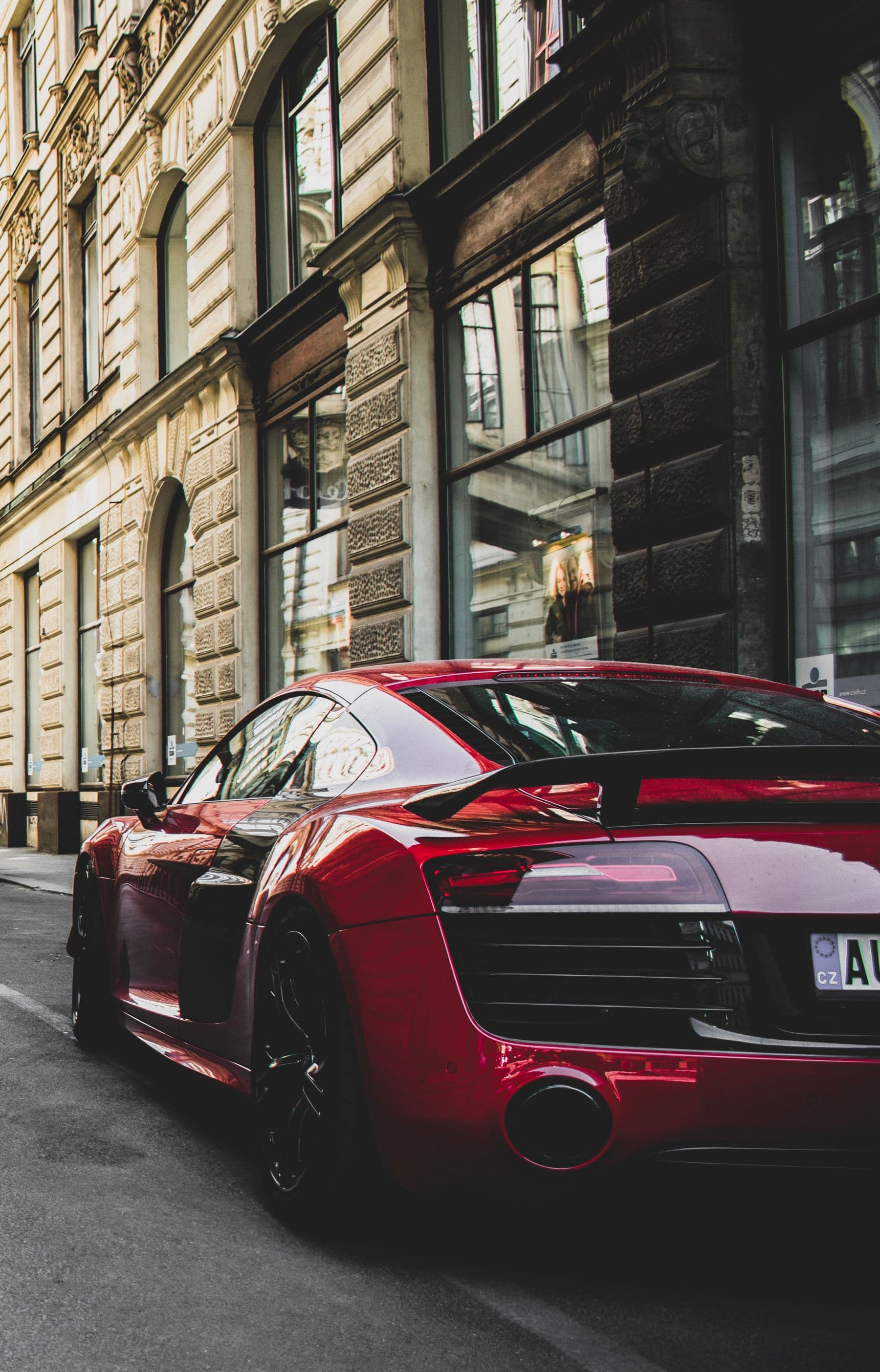 Glossy red luxury sports car on a city street, used as the automotive concept thumbnail.